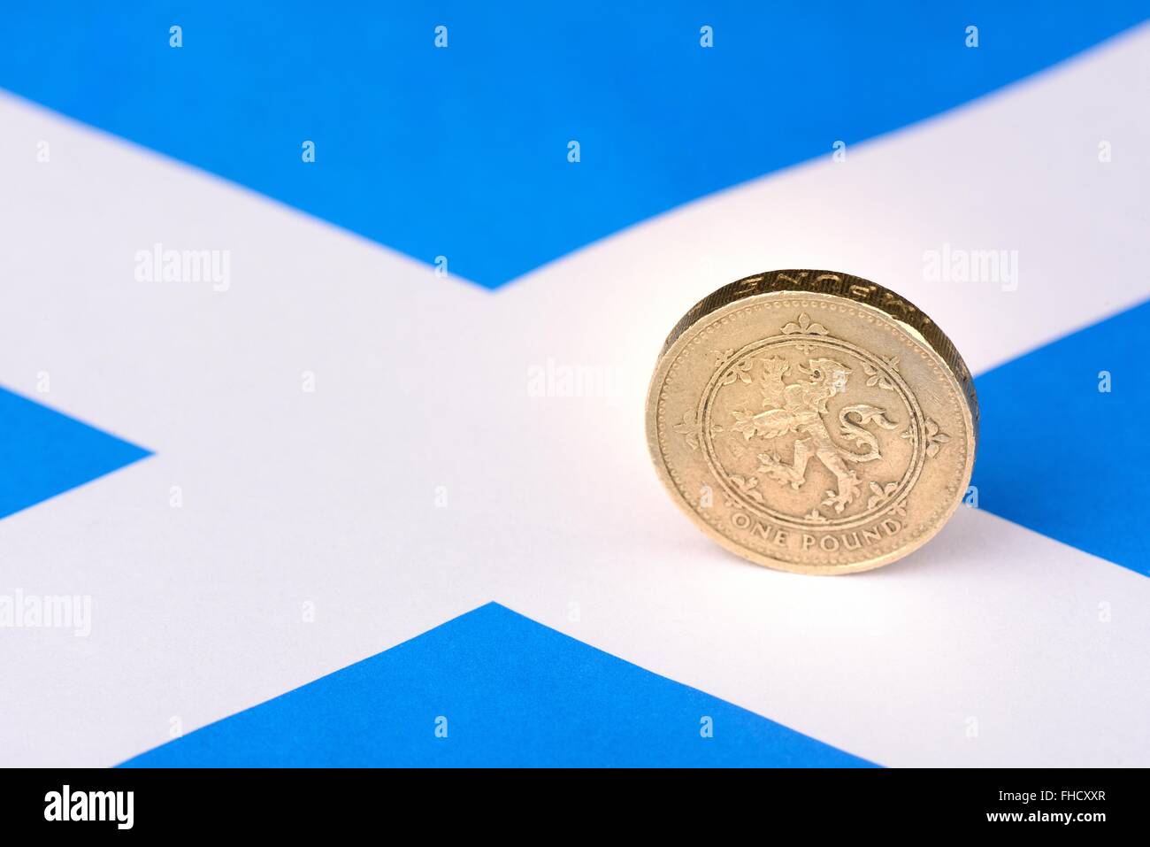Scottish one pound coin showing Lion Rampant on a miniature Scottish flag. Stock Photo