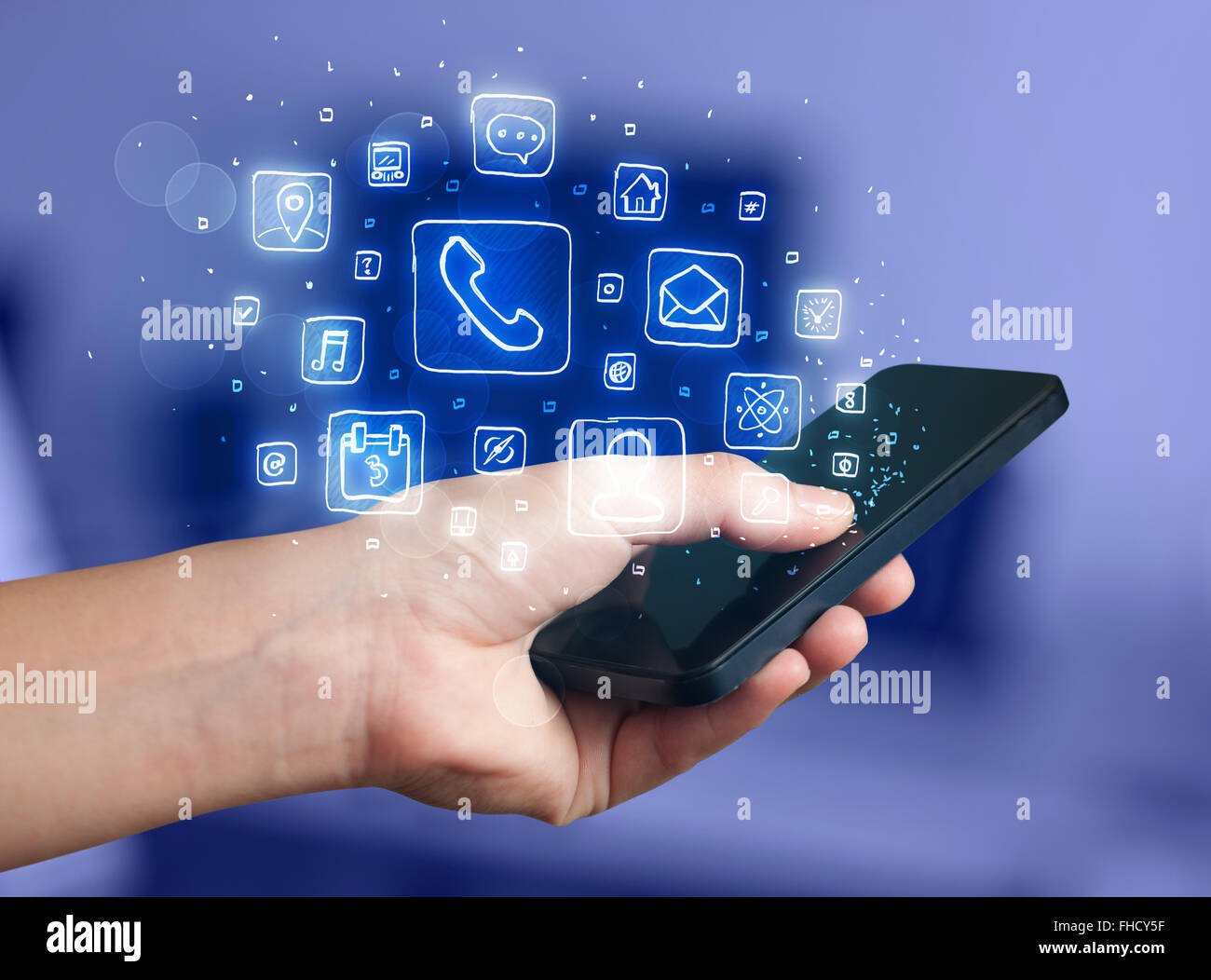 Hand holding smartphone with mobile app icons Stock Photo - Alamy