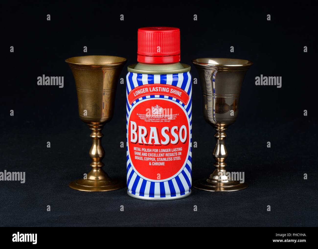 Image shows a well known British metal cleaner beside two identical brass goblets. One has been cleaned and the other not. Stock Photo