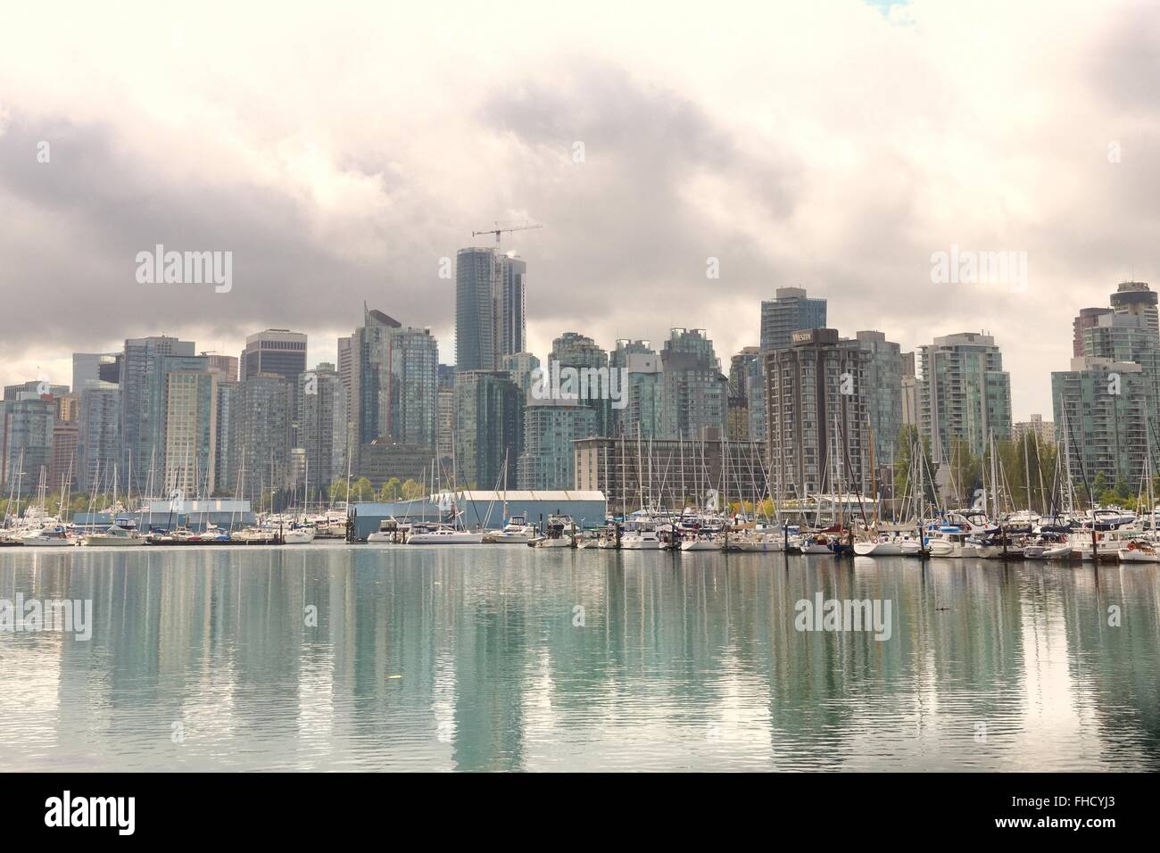 The Vancouver skyline over Vancouver harbour on a cloudy day in BC, Canada. Stock Photo