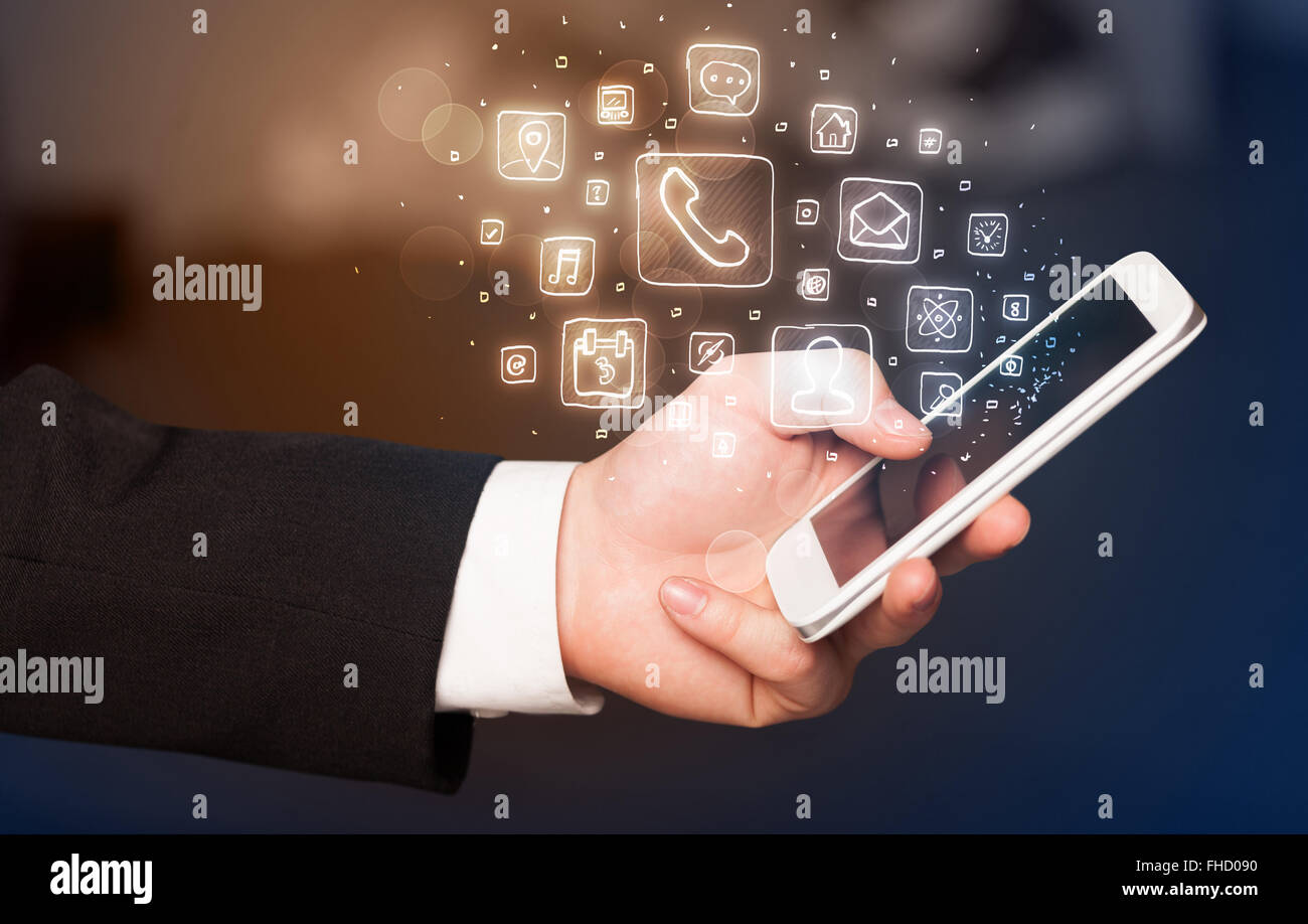 Hand holding smartphone with mobile app icons Stock Photo - Alamy