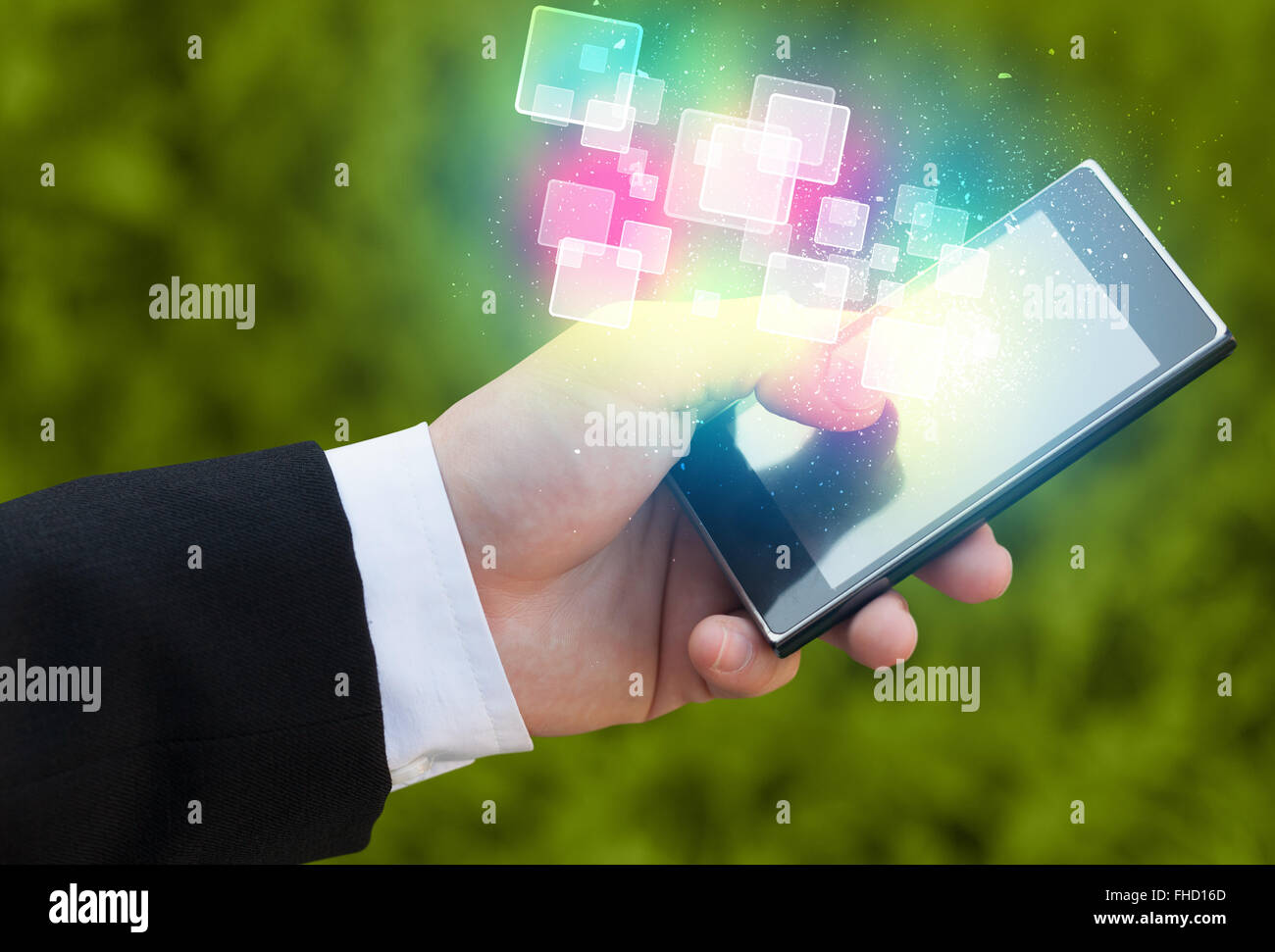 Hand holding smart phone with abstract glowing squares Stock Photo - Alamy