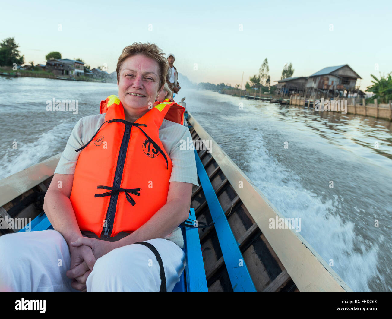 Woman in long speedboat. Inle lake, Burma Stock Photo