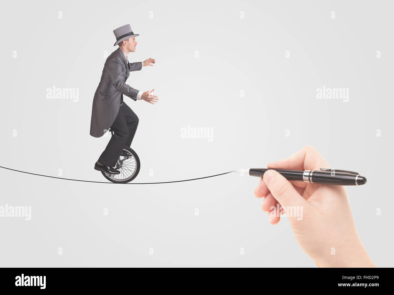 Businessman riding monocycle on a rope drawn by hand Stock Photo
