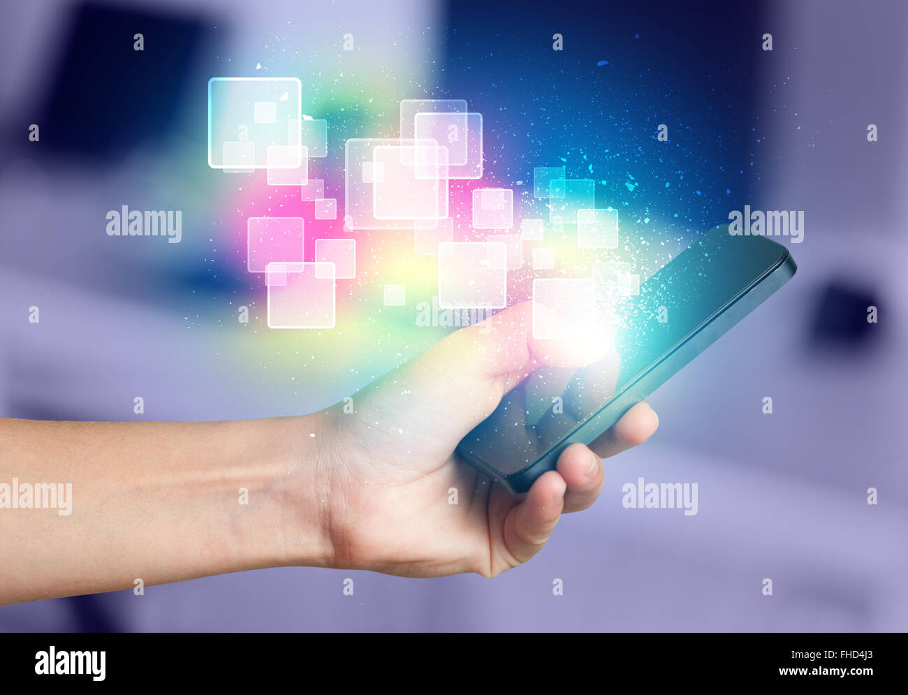 Hand holding smart phone with abstract glowing squares Stock Photo - Alamy
