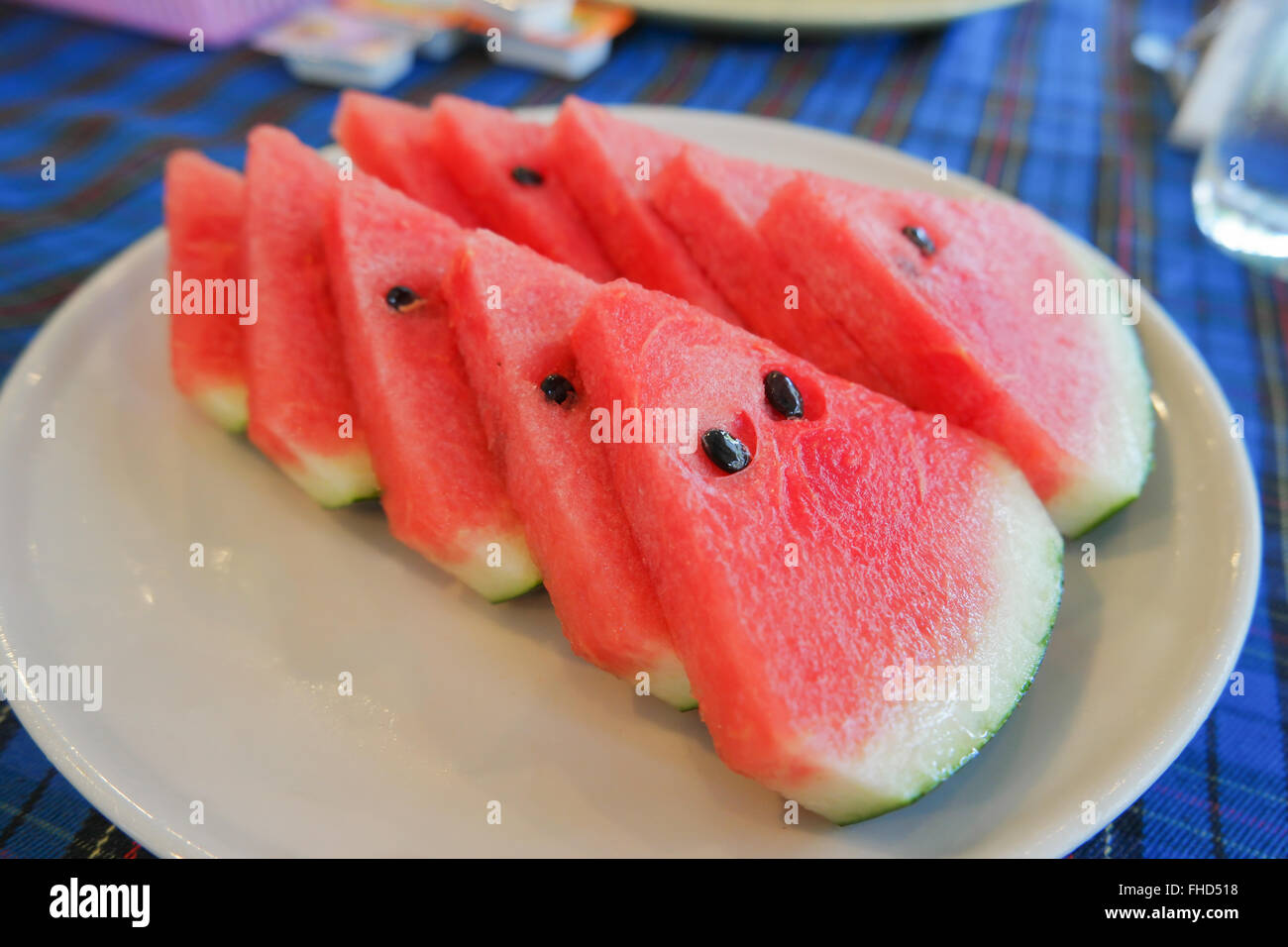 Watermelon In the white plate on the dining table. Stock Photo