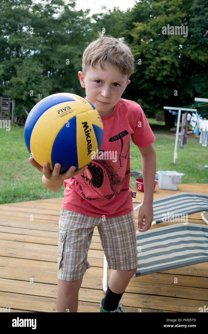 Polish boy age 10 playing intensity with a yellow and blue ball on his deck. Zawady Central