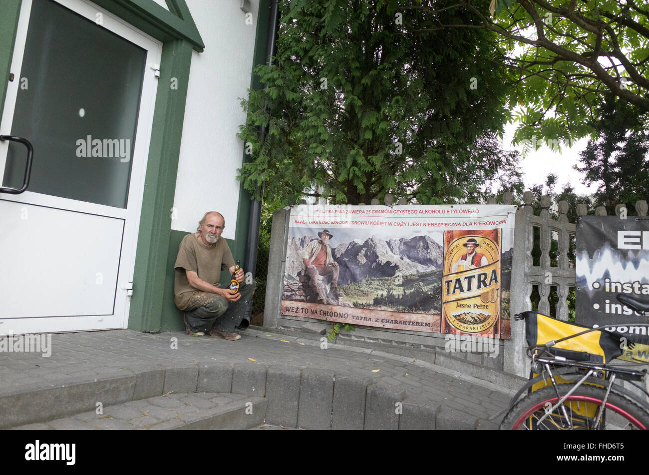 Not unusual for a Polish gentleman to enjoy a beer outside of a grocery store. Rzeczyca Central Poland Stock Photo