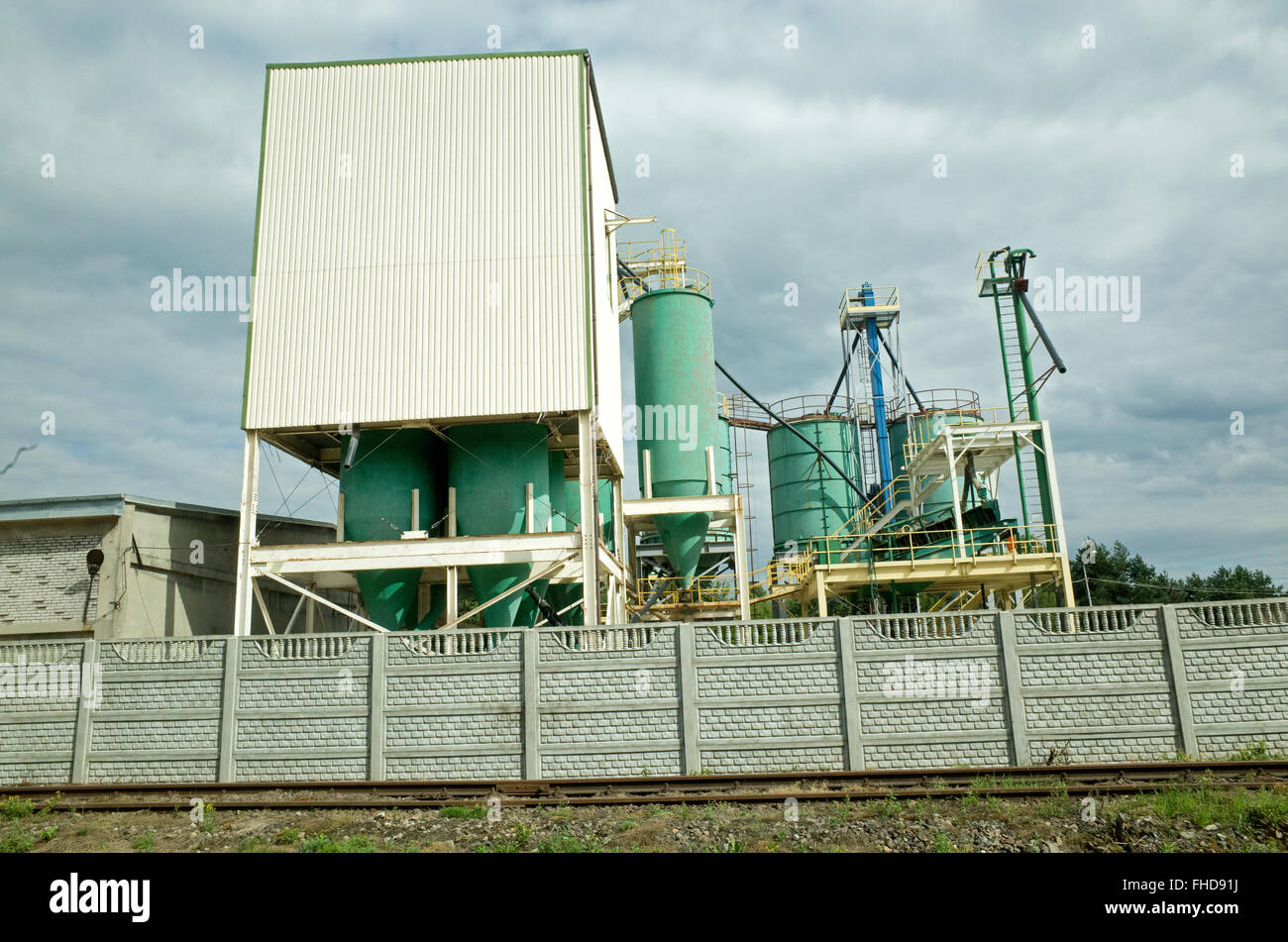 Polish industrial complex with large vertical storage tanks beside