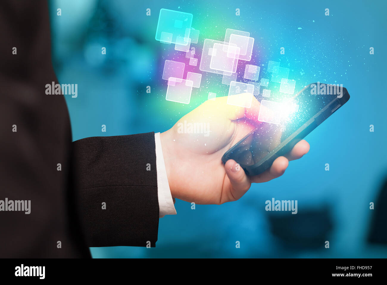 Hand holding smart phone with abstract glowing squares Stock Photo - Alamy