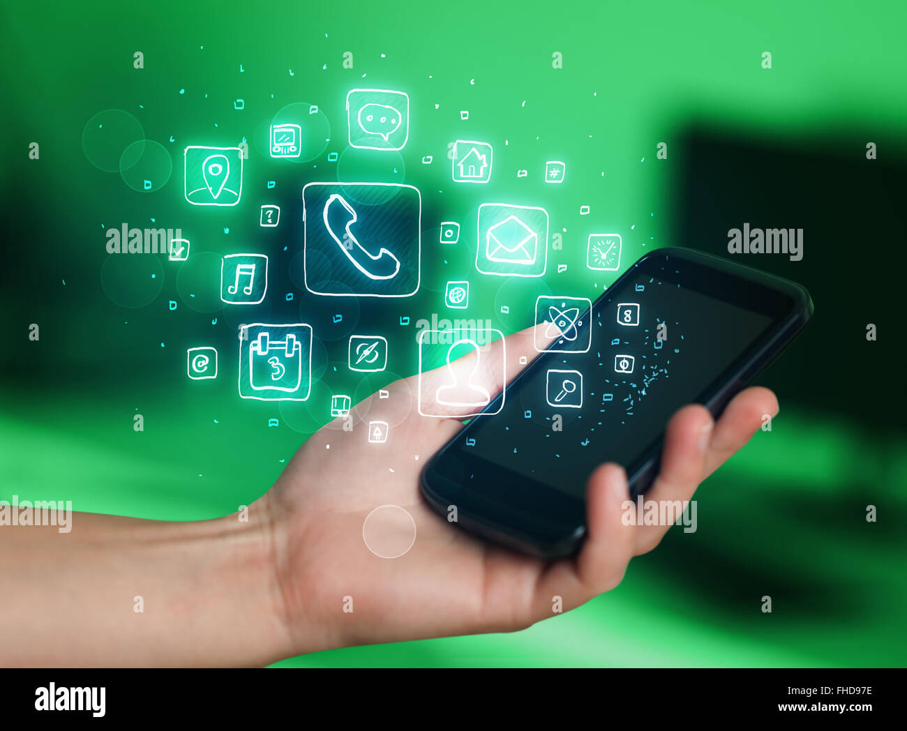 Hand holding smartphone with mobile app icons Stock Photo - Alamy