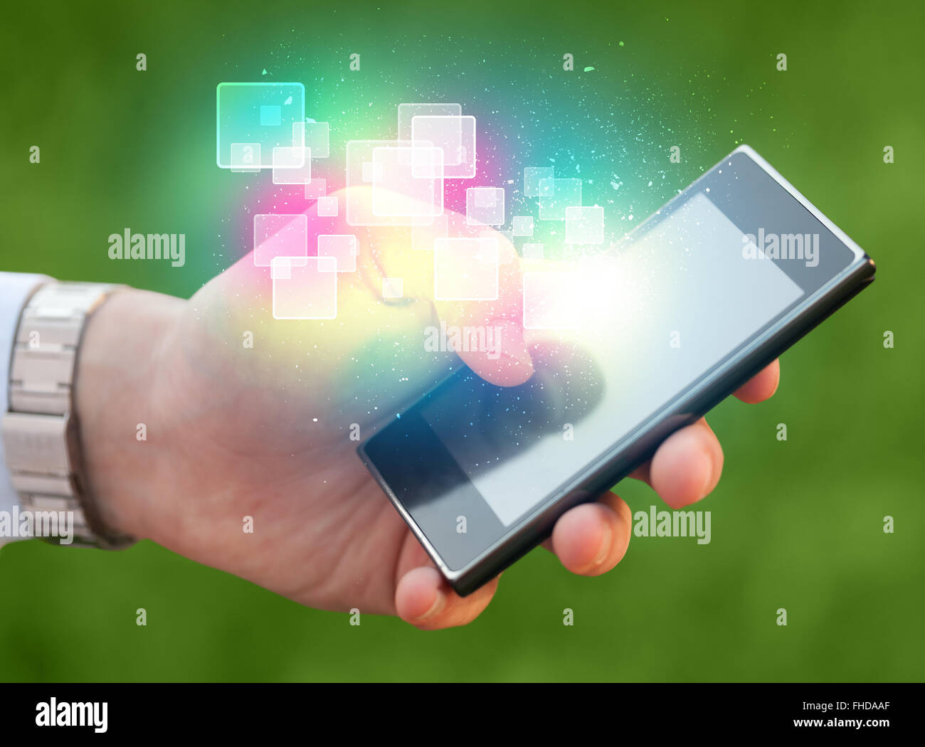Hand holding smart phone with abstract glowing squares Stock Photo - Alamy