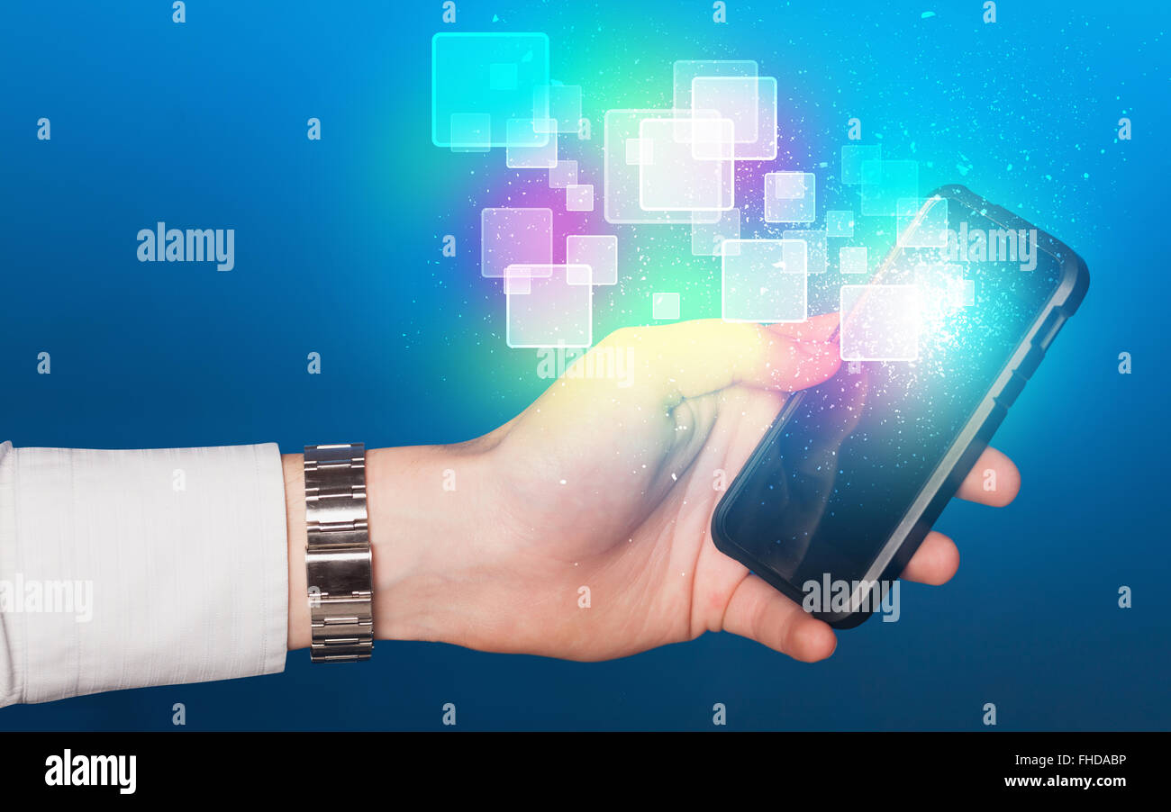 Hand holding smart phone with abstract glowing squares Stock Photo - Alamy