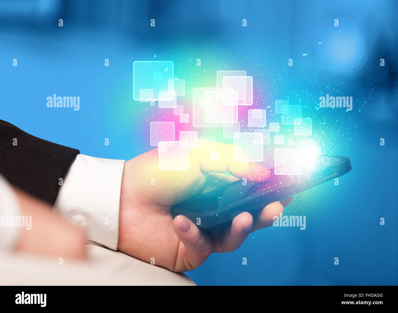 Hand holding smart phone with abstract glowing squares Stock Photo - Alamy