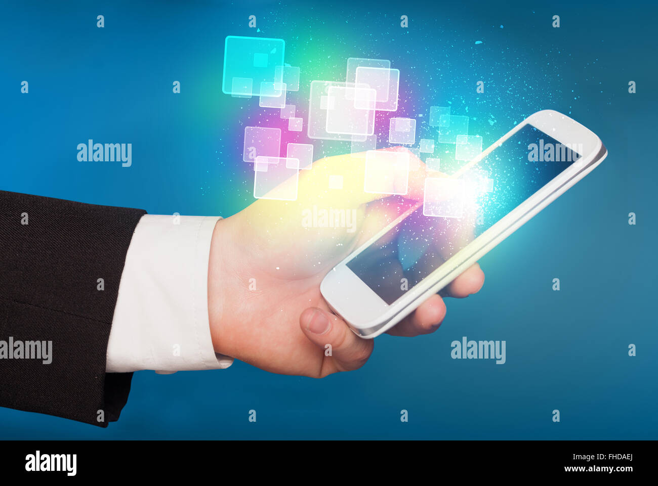 Hand holding smart phone with abstract glowing squares Stock Photo - Alamy