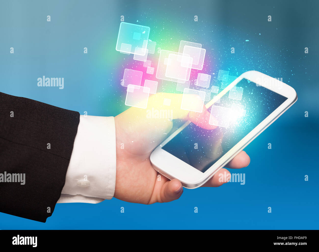 Hand holding smart phone with abstract glowing squares Stock Photo - Alamy