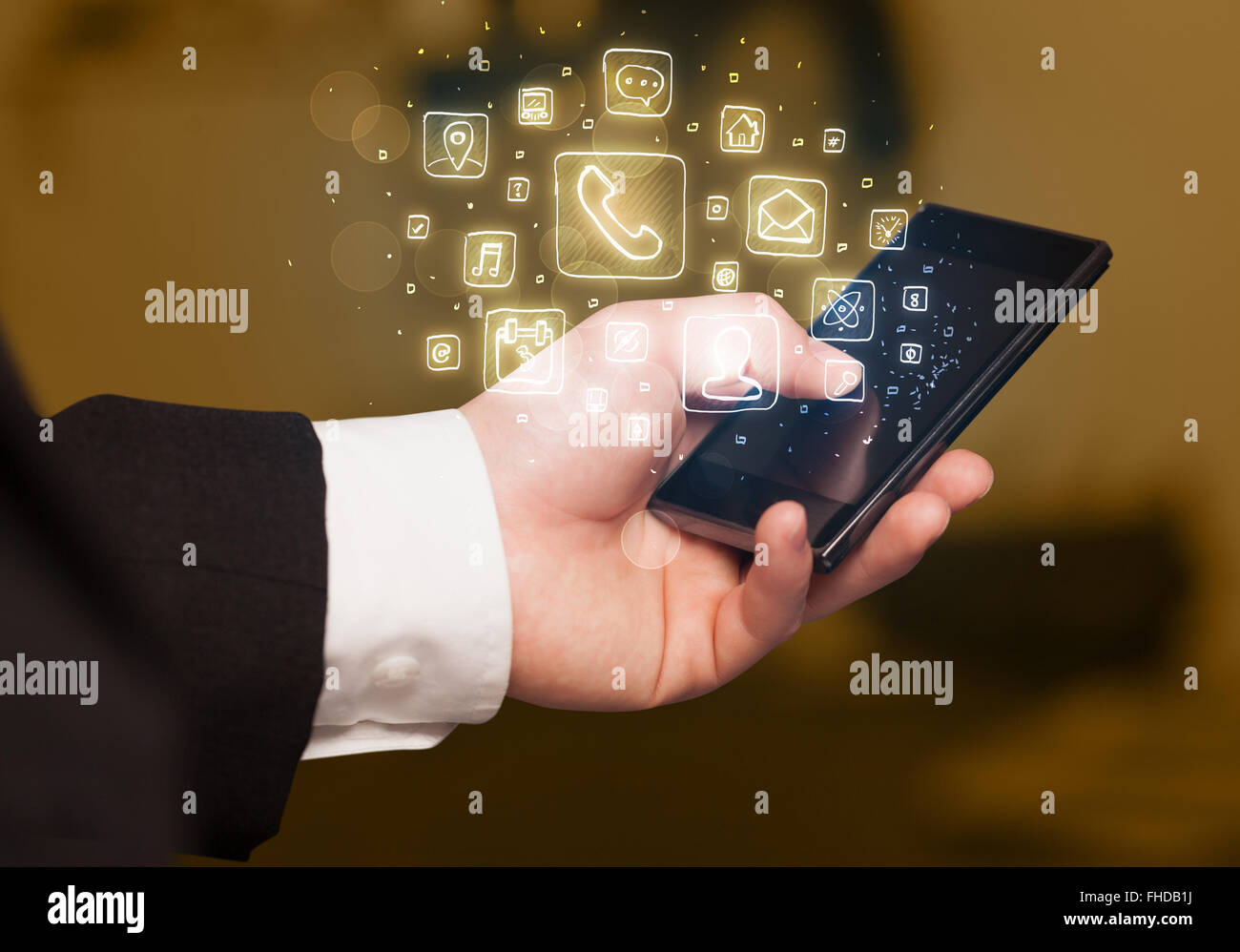 Hand holding smartphone with mobile app icons Stock Photo - Alamy
