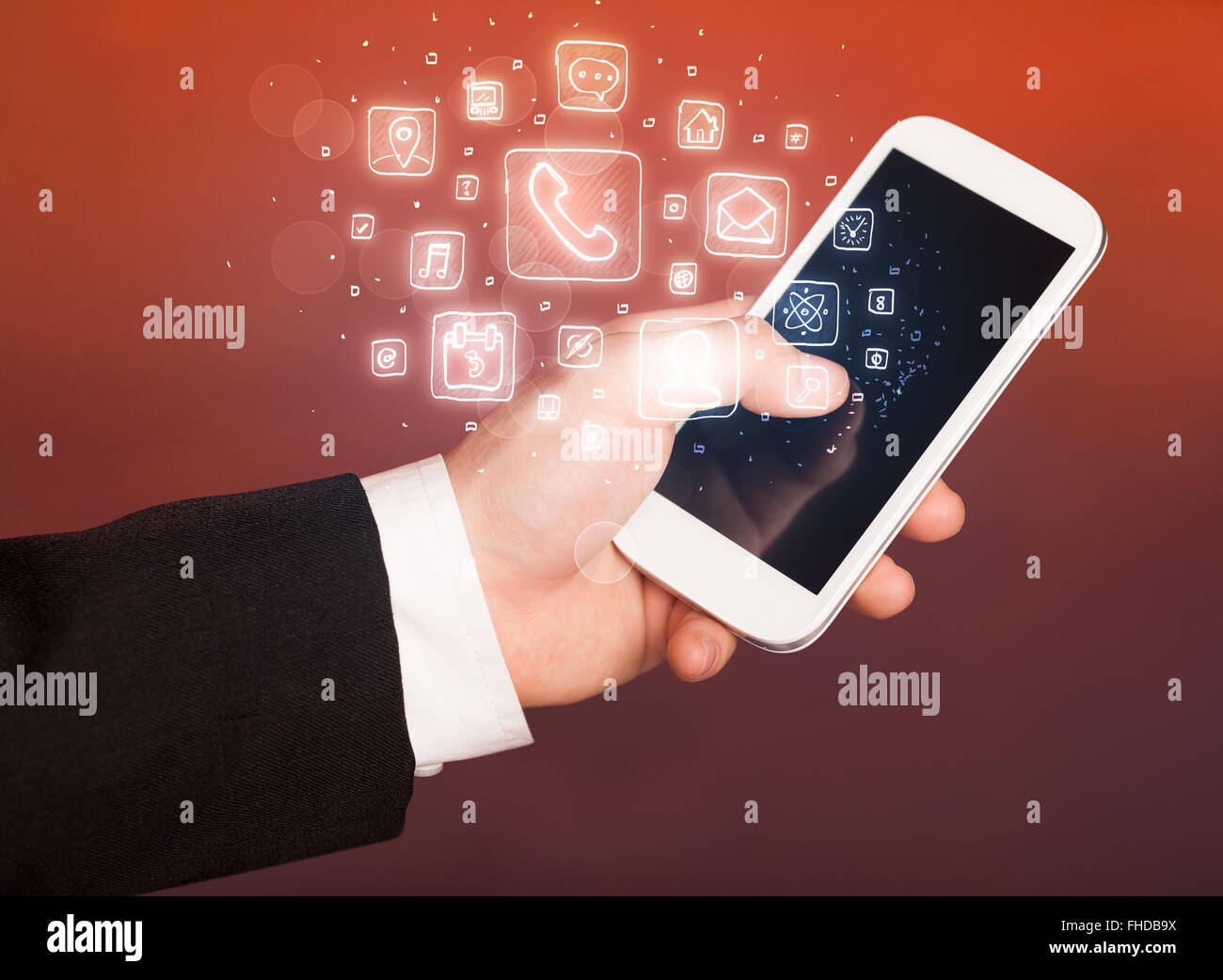 Hand holding smartphone with mobile app icons Stock Photo - Alamy