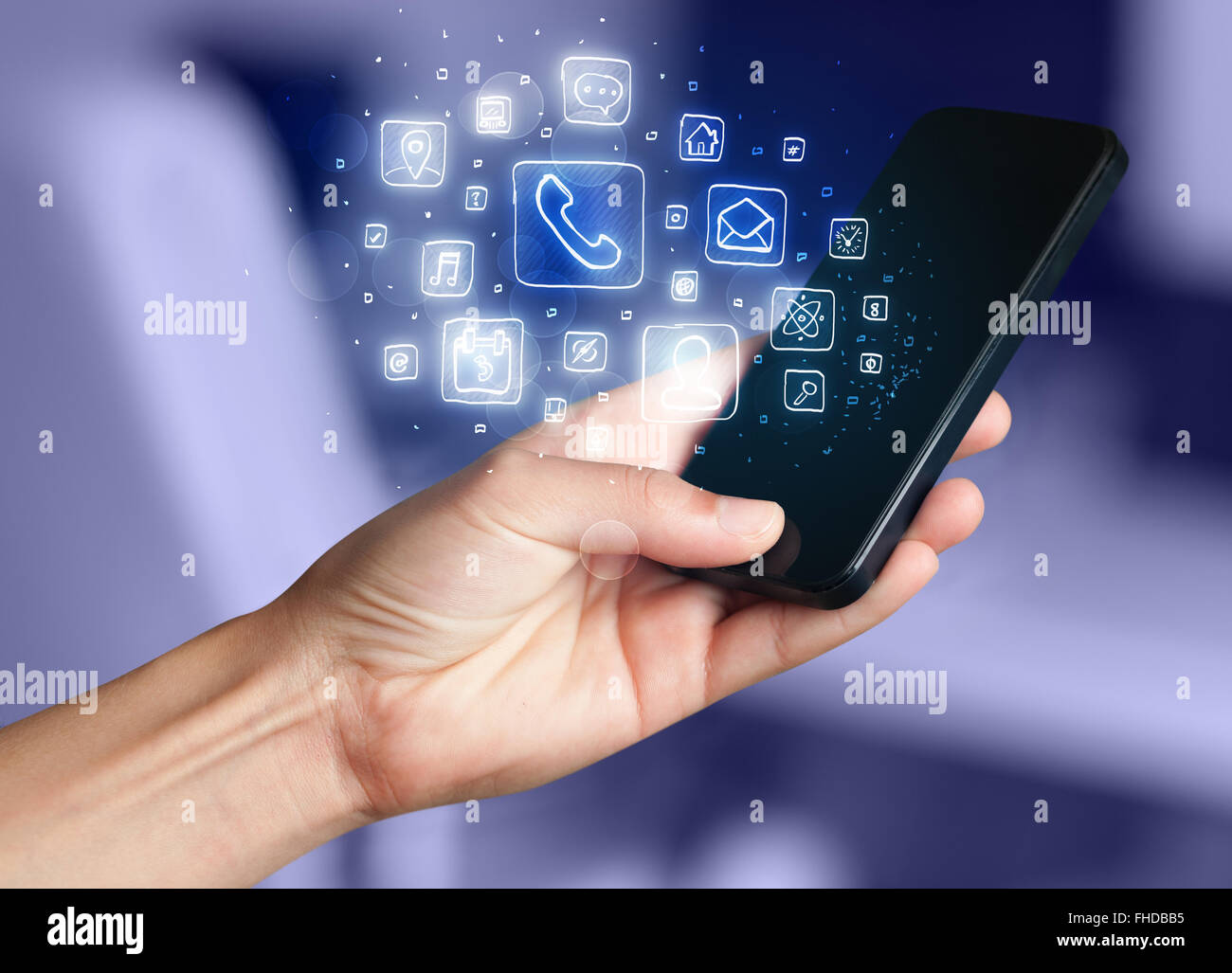 Hand holding smartphone with mobile app icons Stock Photo - Alamy