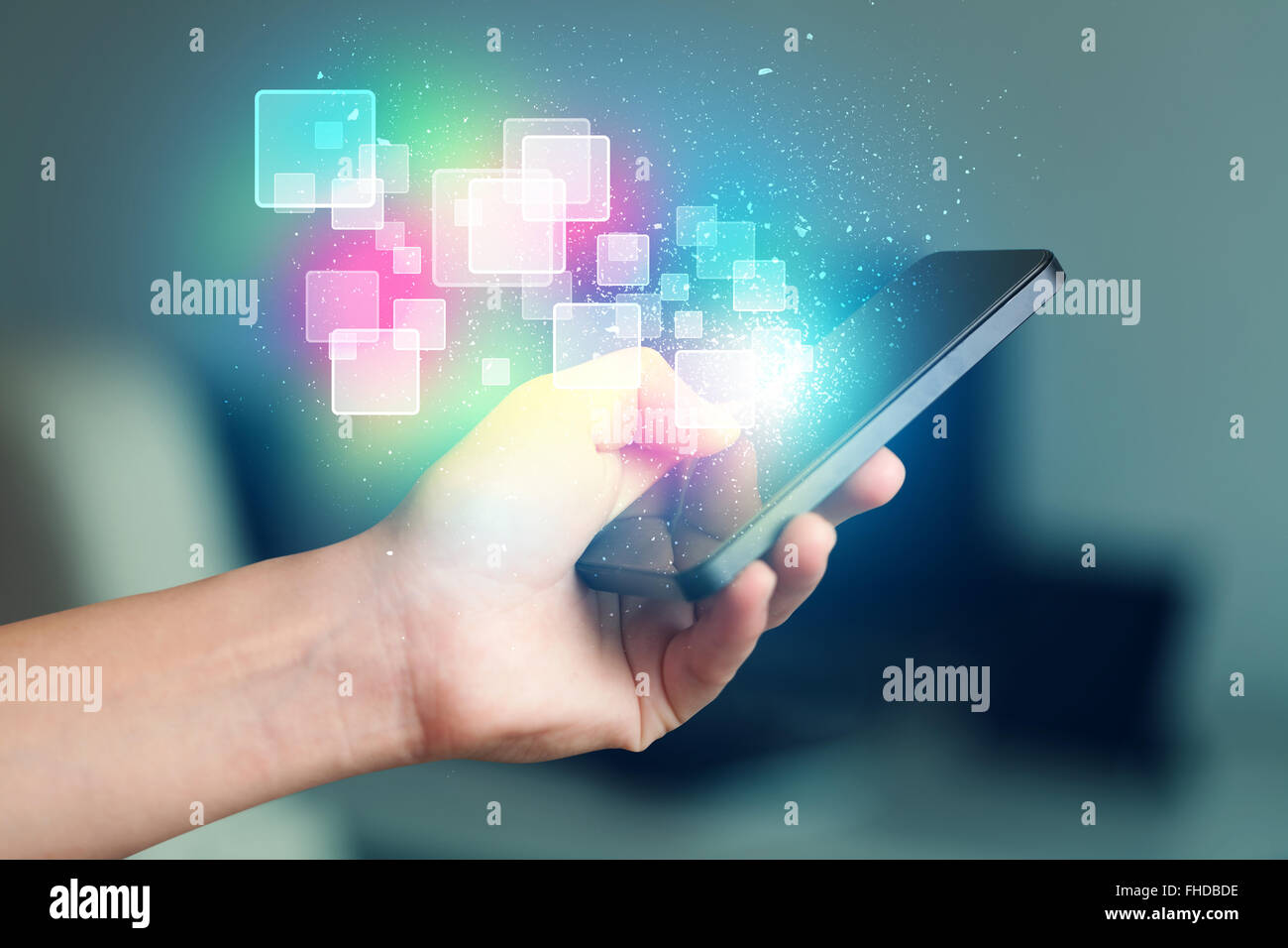 Hand holding smart phone with abstract glowing squares Stock Photo - Alamy