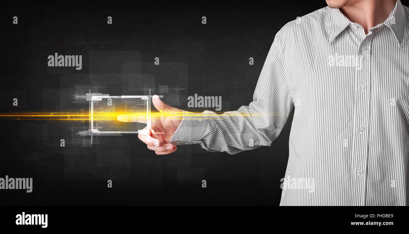 Tech business person touching button with orange light beams concept ...