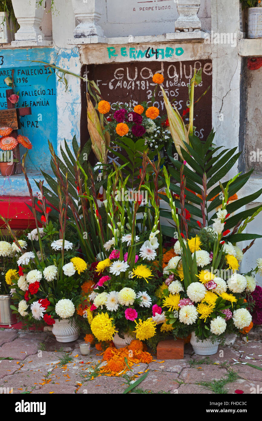 GRAVES are covered with FRESH FLOWERS to loved ones back to earth during DAY OF THE DEAD