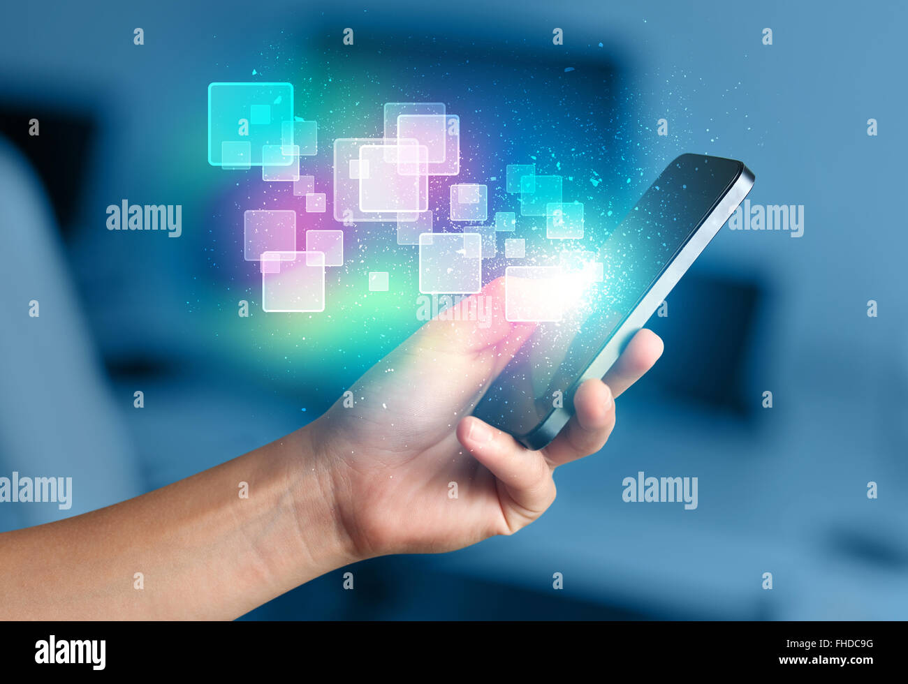 Hand holding smart phone with abstract glowing squares Stock Photo - Alamy