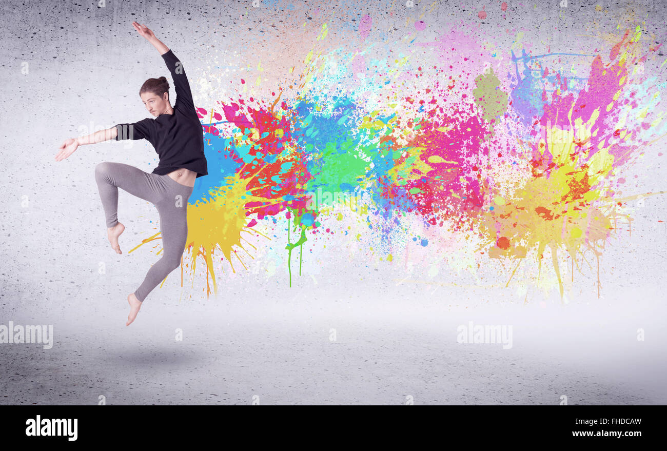 Modern street dancer jumping with colorful paint splashes Stock Photo ...