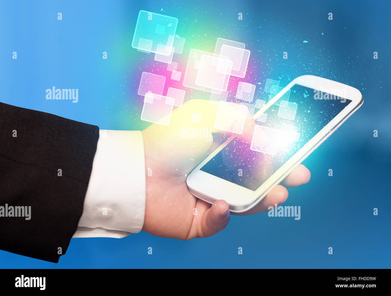Hand holding smart phone with abstract glowing squares Stock Photo - Alamy