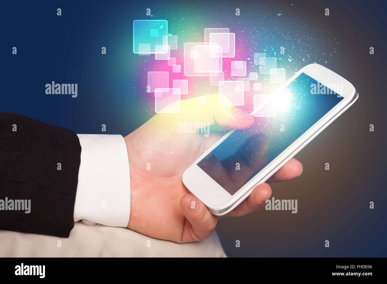 Hand holding smart phone with abstract glowing squares Stock Photo - Alamy