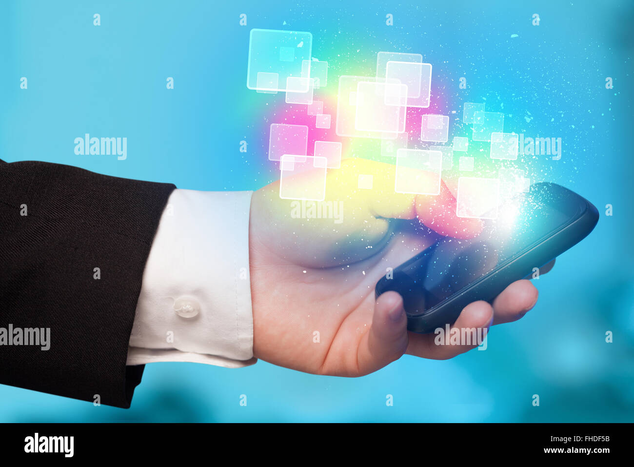Hand holding smart phone with abstract glowing squares Stock Photo - Alamy