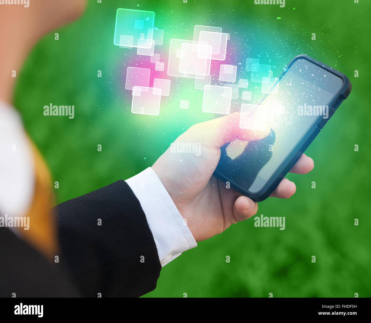 Hand holding smart phone with abstract glowing squares Stock Photo - Alamy