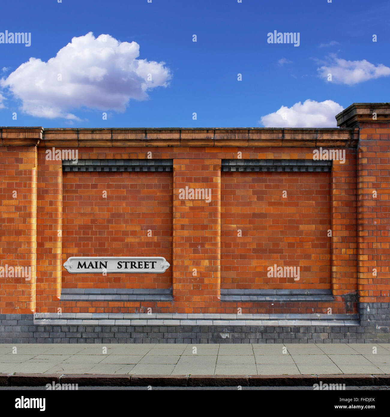 A Red Brick Wall with Main Street Sign and Sidewalk Stock Photo Alamy