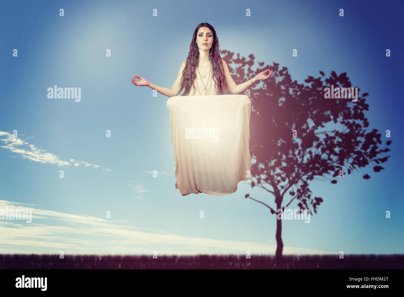 Composite image of portrait of beautiful woman levitating Stock Photo