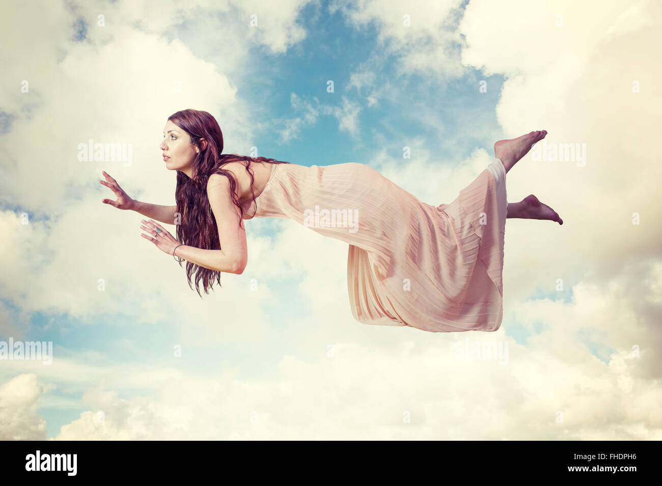 Composite image of full length of woman levitating Stock Photo - Alamy