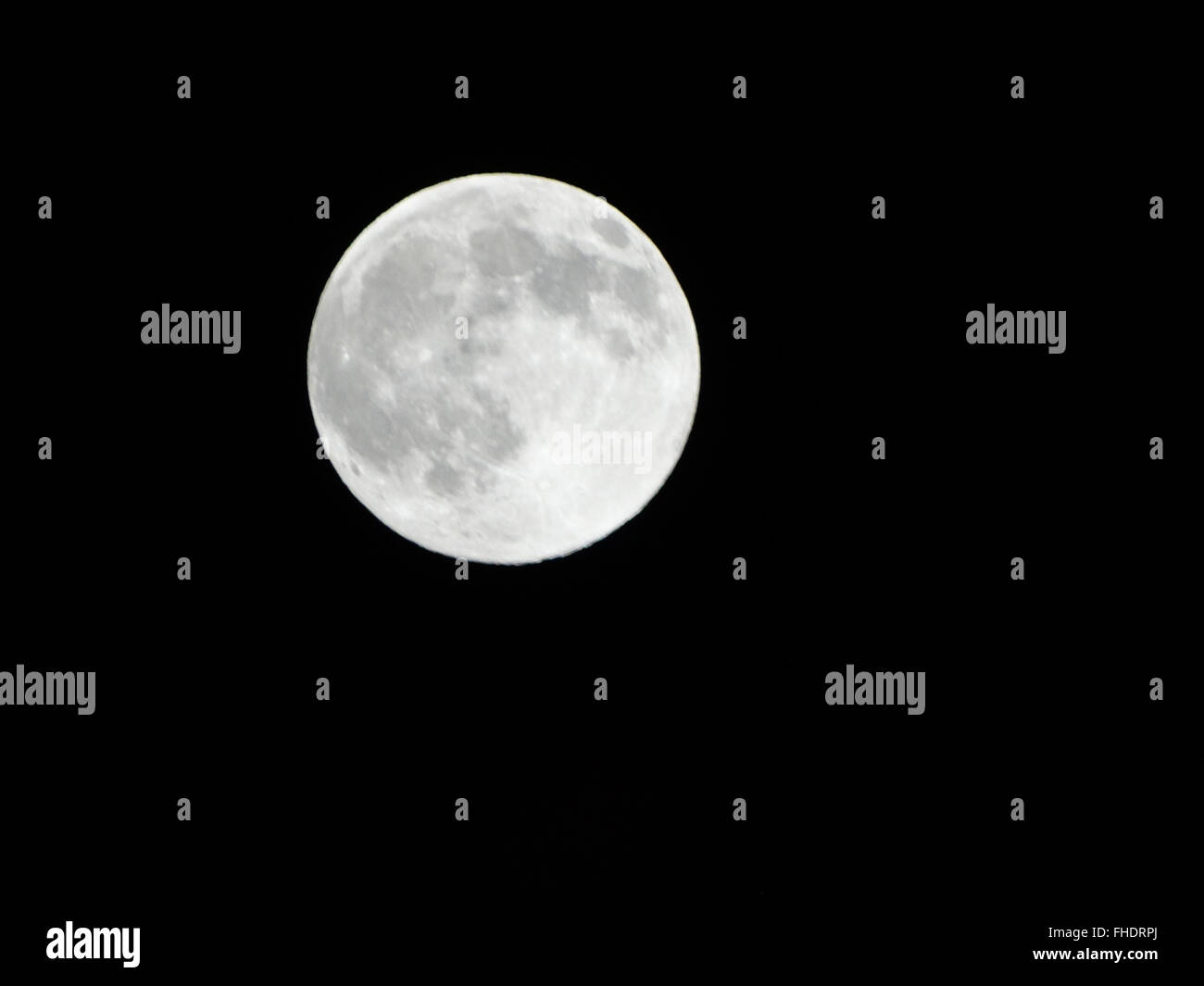 Full moon on clear black sky in Sunnyvale, California, sky black with white rounded moon with gray topography Stock Photo