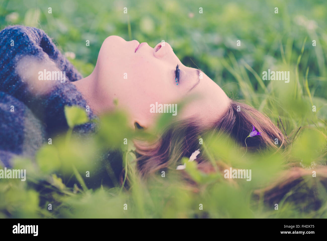 Woman with closed eyes lying on a meadow Stock Photo - Alamy