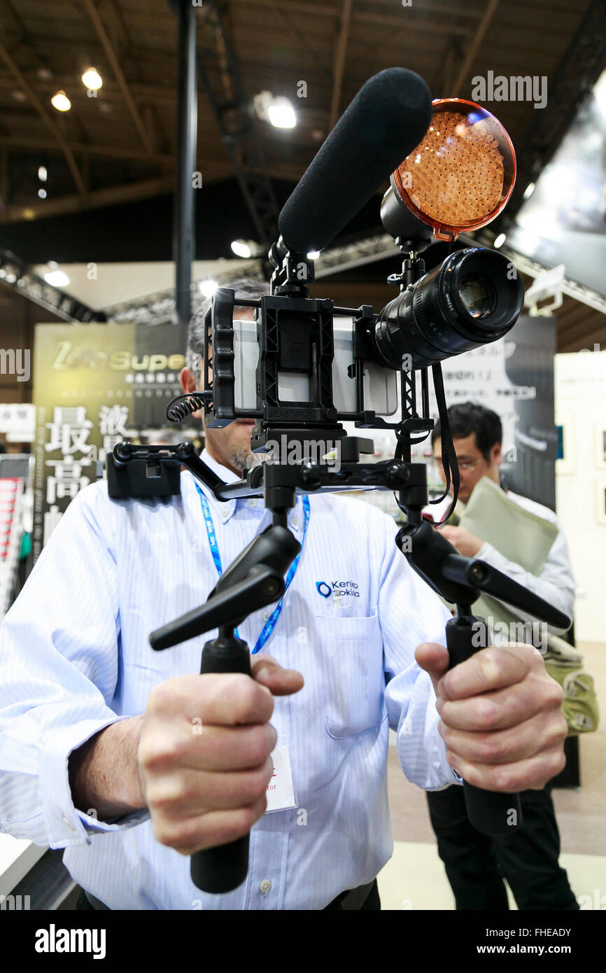 Yokohama, Japan. 25th February, 2016. A exhibitor holds a steadicam for smartphone at the CP  2016 Camera & Imaging Show on February 25, 2016, in Yokohama, Japan. CP  is the biggest camera and photo imaging showcase in Japan with 132 exhibitors across 1,073 booths in Osanbashi Hall and Pacifico Yokohama, and organizers expect 70,000 visitors over the course of the exhibition that runs until Sunday 28th. Credit:  Rodrigo Reyes Marin/AFLO/Alamy Live News Stock Photo