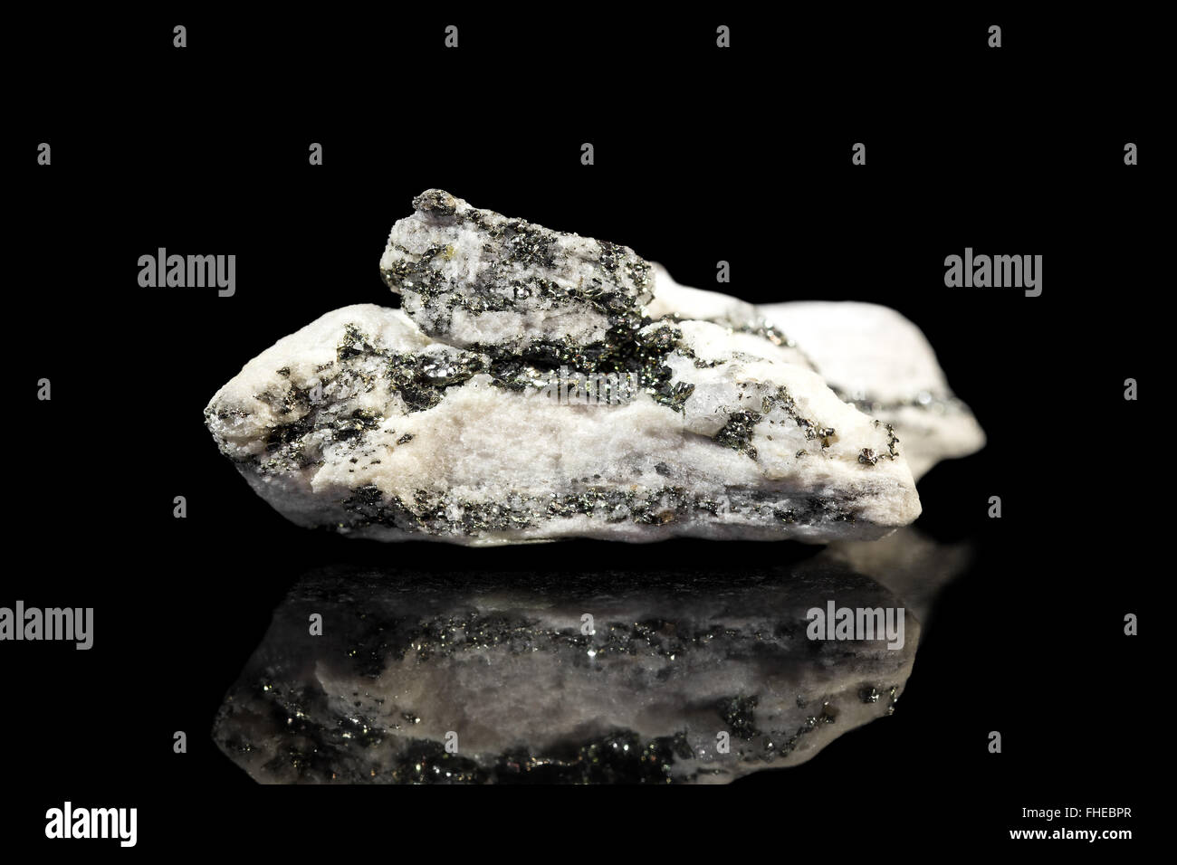 white dolomite mineral stone with pyrite, gemstone with reflections, black background Stock Photo