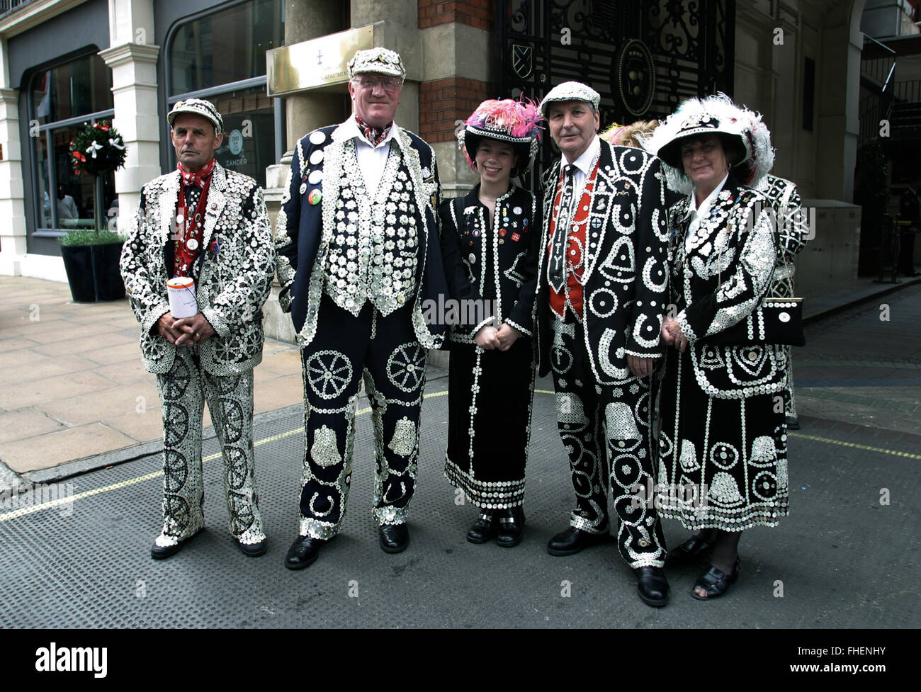 A group of pearly kings and queens pictured at Buckinham Gate on the way to celebrate Queen Elizabeth II's Golden Jubilee. Celebrations took place across the United Kingdom with the centrepiece a parade and fireworks at Buckingham Palace, the Queen's London residency. Queen Elizabeth ascended to the British throne in 1952 upon the death of her father, King George VI. Stock Photo