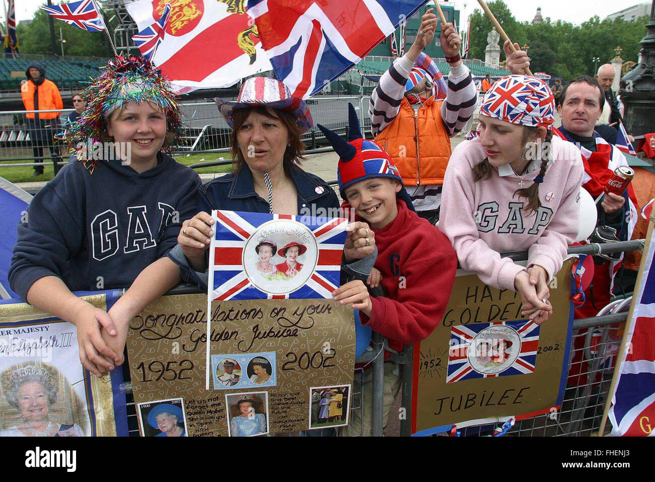 A family from London who camped out overnight outside Buckingham Palace to secure the best viewing positions for the two-day Golden Jubilee celebrations to mark the 50 year reign of Queen Elizabeth II. Celebrations took place across the United Kingdom with the centrepiece a parade and fireworks at Buckingham Palace, the Queen's London residency. Queen Elizabeth ascended to the British throne in 1952 upon the death of her father, King George VI. Stock Photo