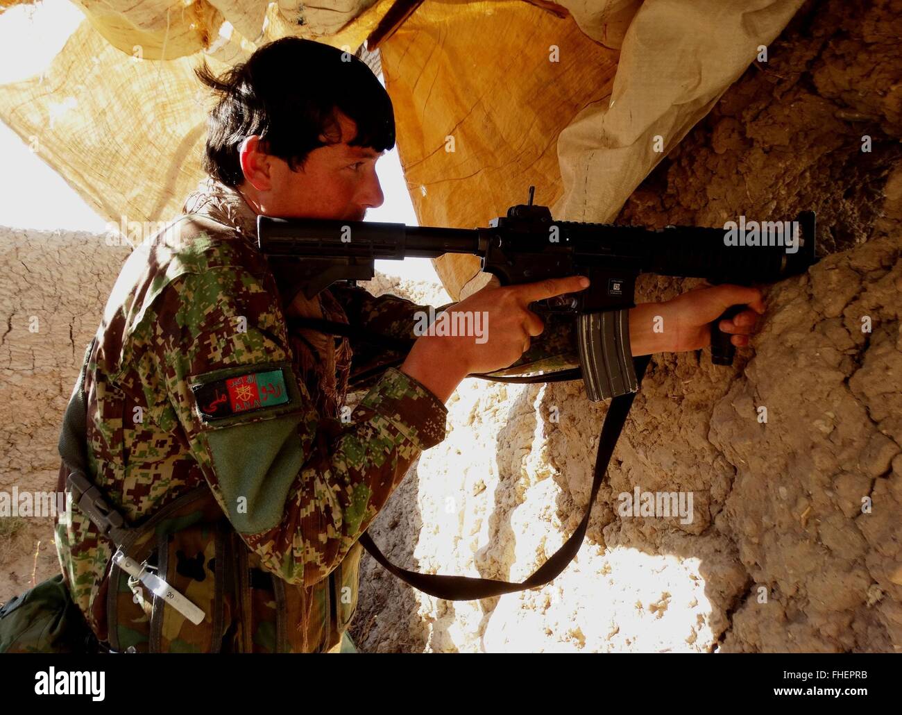 Helmand, Afghanistan. 24th Feb, 2016. An Afghan security force member takes position during a military operation in Helmand province, Afghanistan, Feb. 24, 2016. Credit:  Abdul Aziz Safdari/Xinhua/Alamy Live News Stock Photo