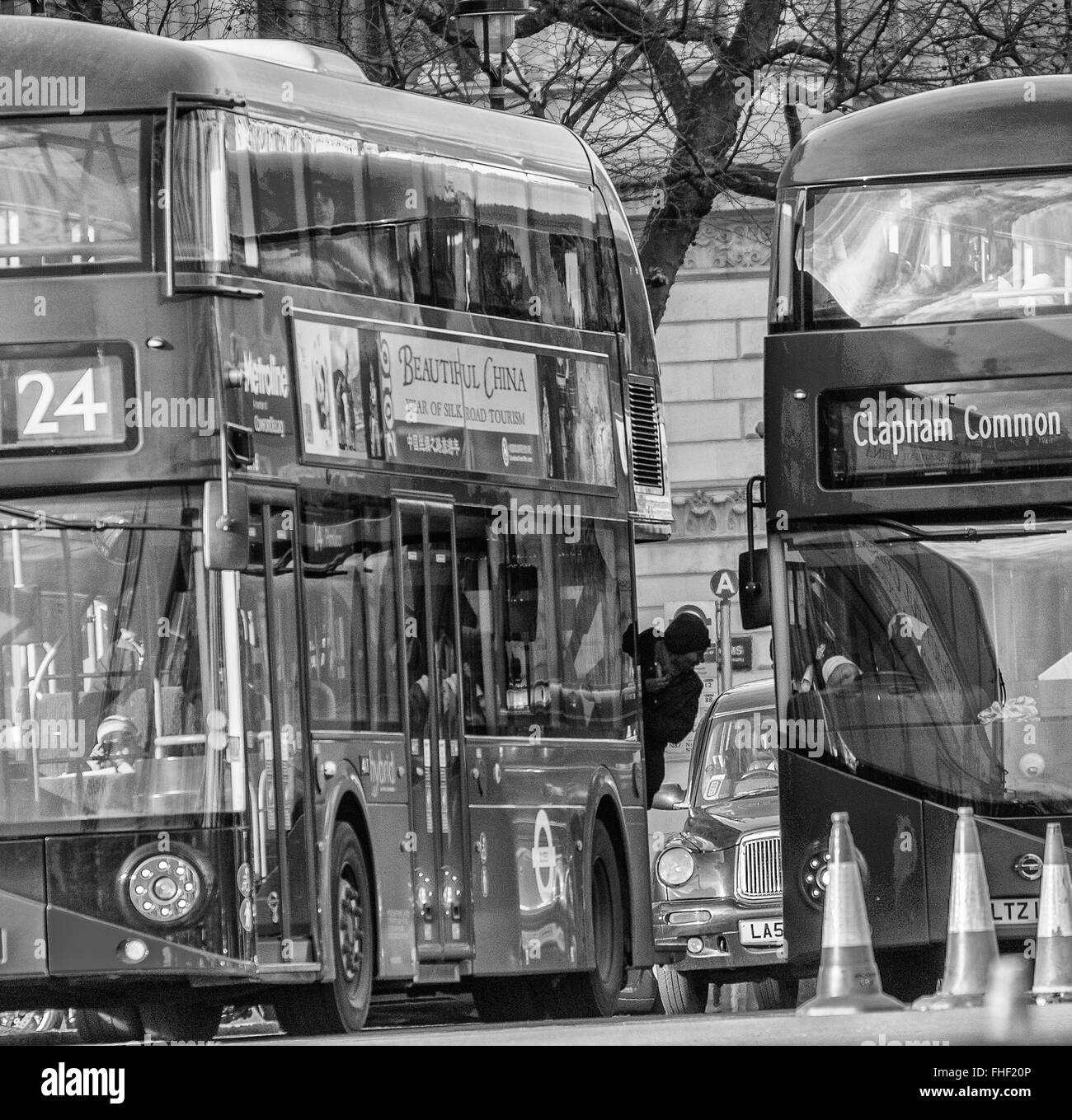 Man leaning out of London bus Stock Photo