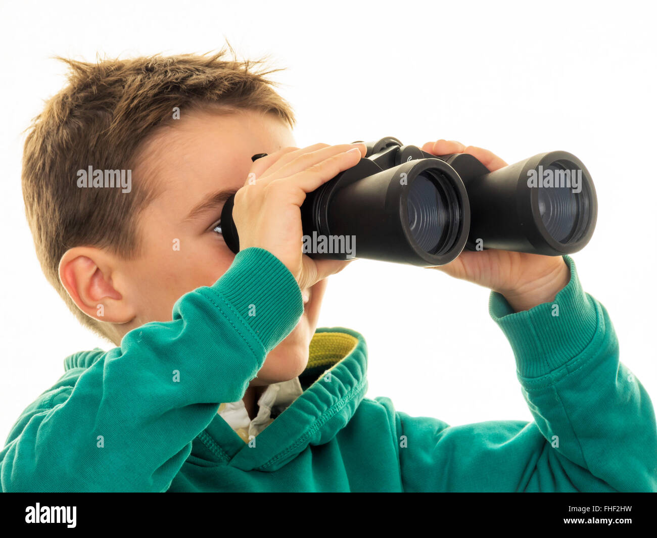 Boy looking through binoculars Stock Photo