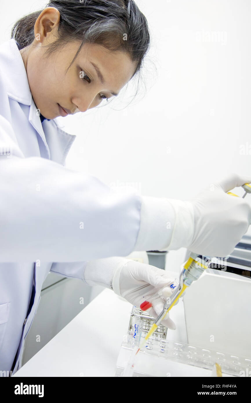 woman working with pipette for test blood in a laboratory in hospital ...