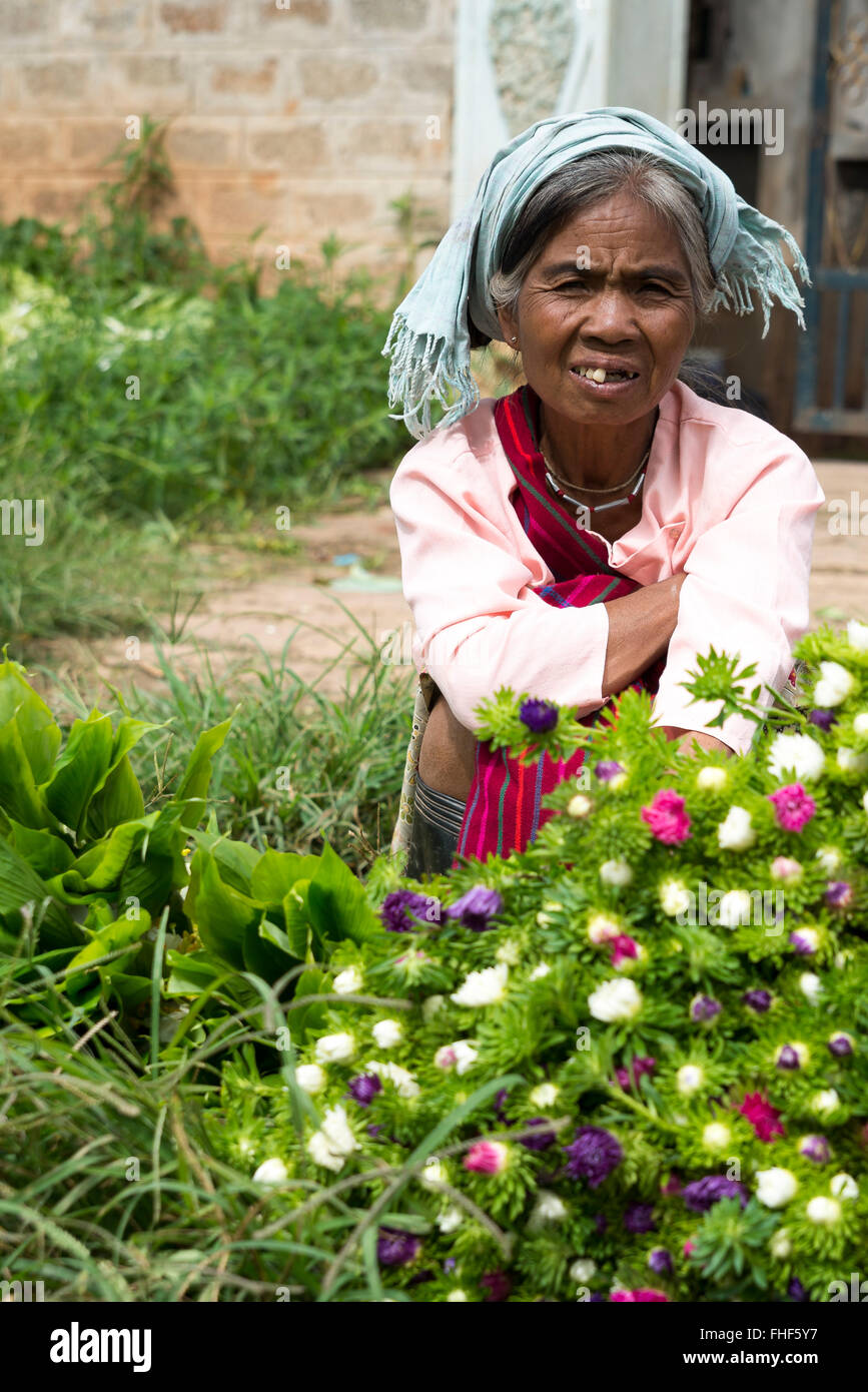 Woman sells flowers, Pao hilltribe, Kalaw market, Shan State, Myanmar, Burma Stock Photo