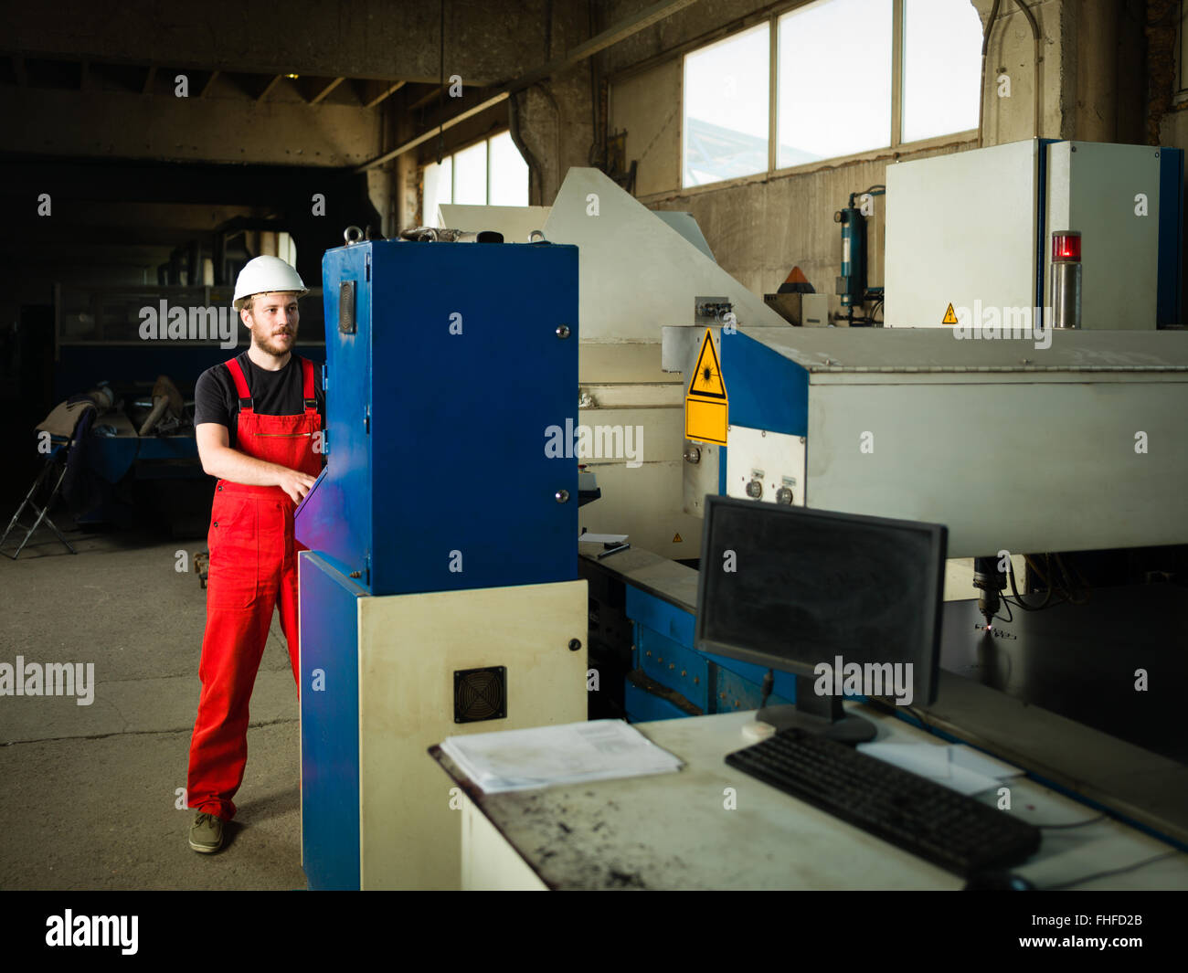 Man wearing blue overalls hi-res stock photography and images - Alamy