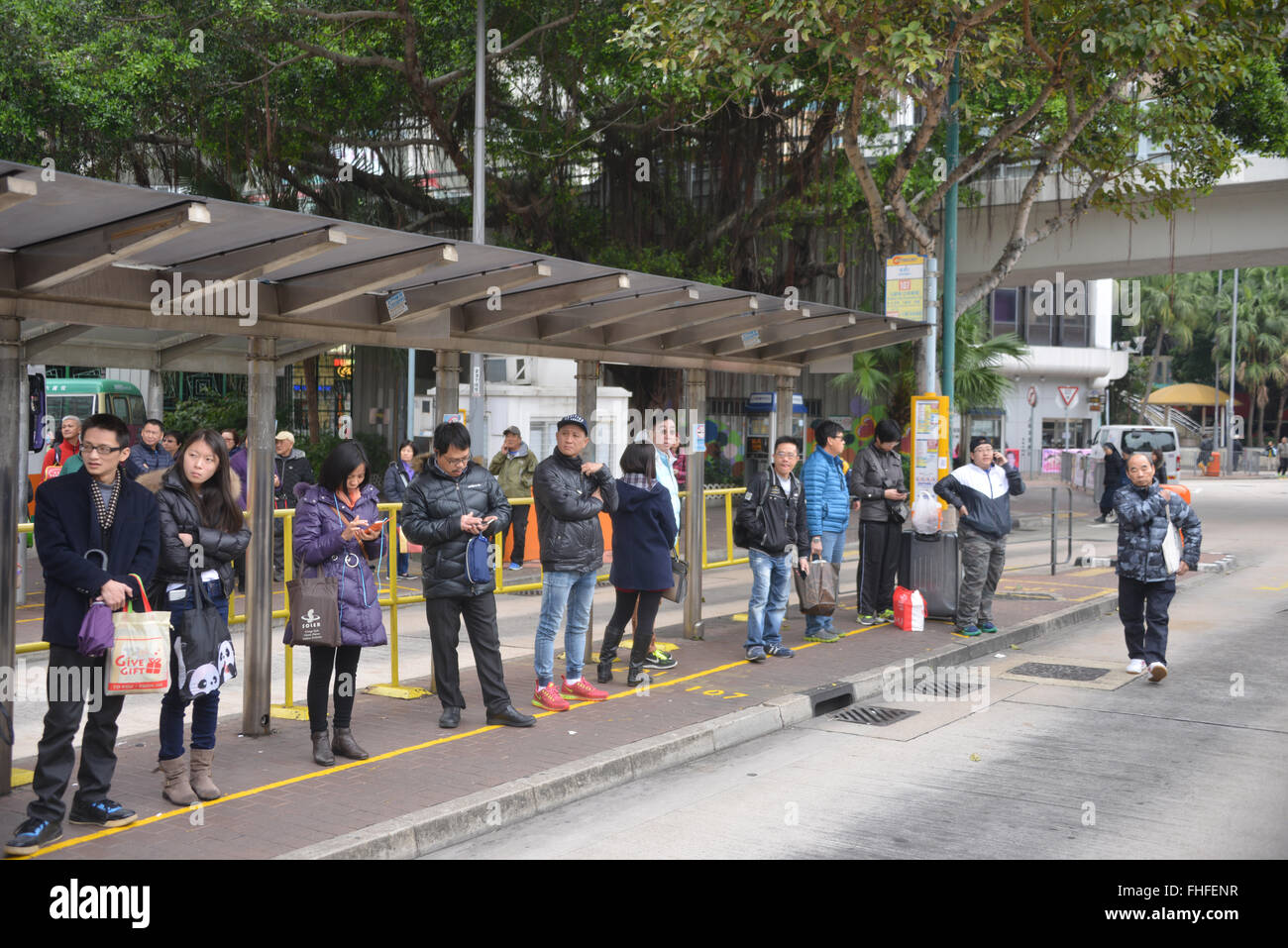 People waiting for buses, Aberdeen, Hong Kong Island Stock Photo