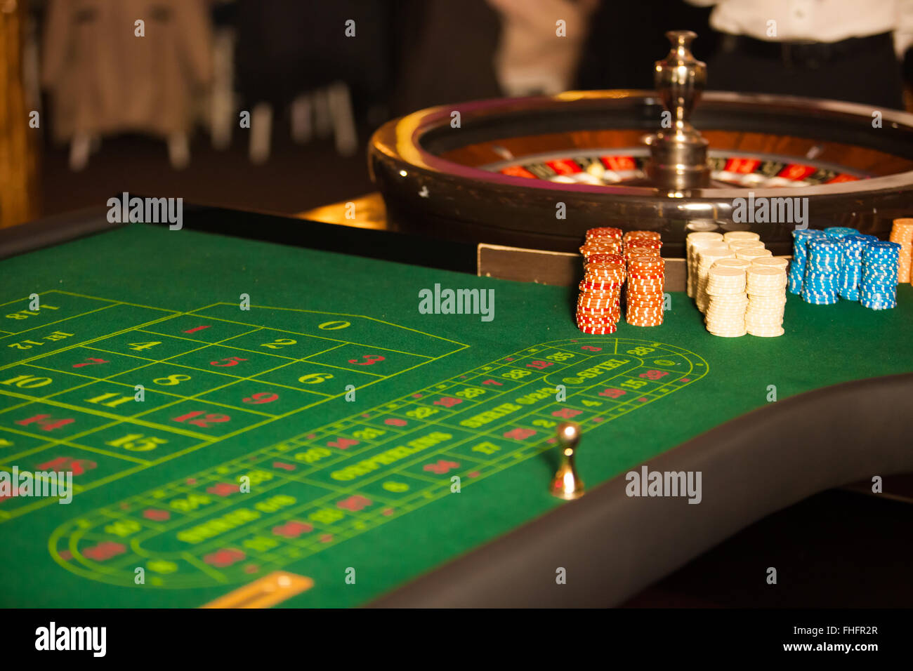 Casino table with roulette and chips Stock Photo - Alamy