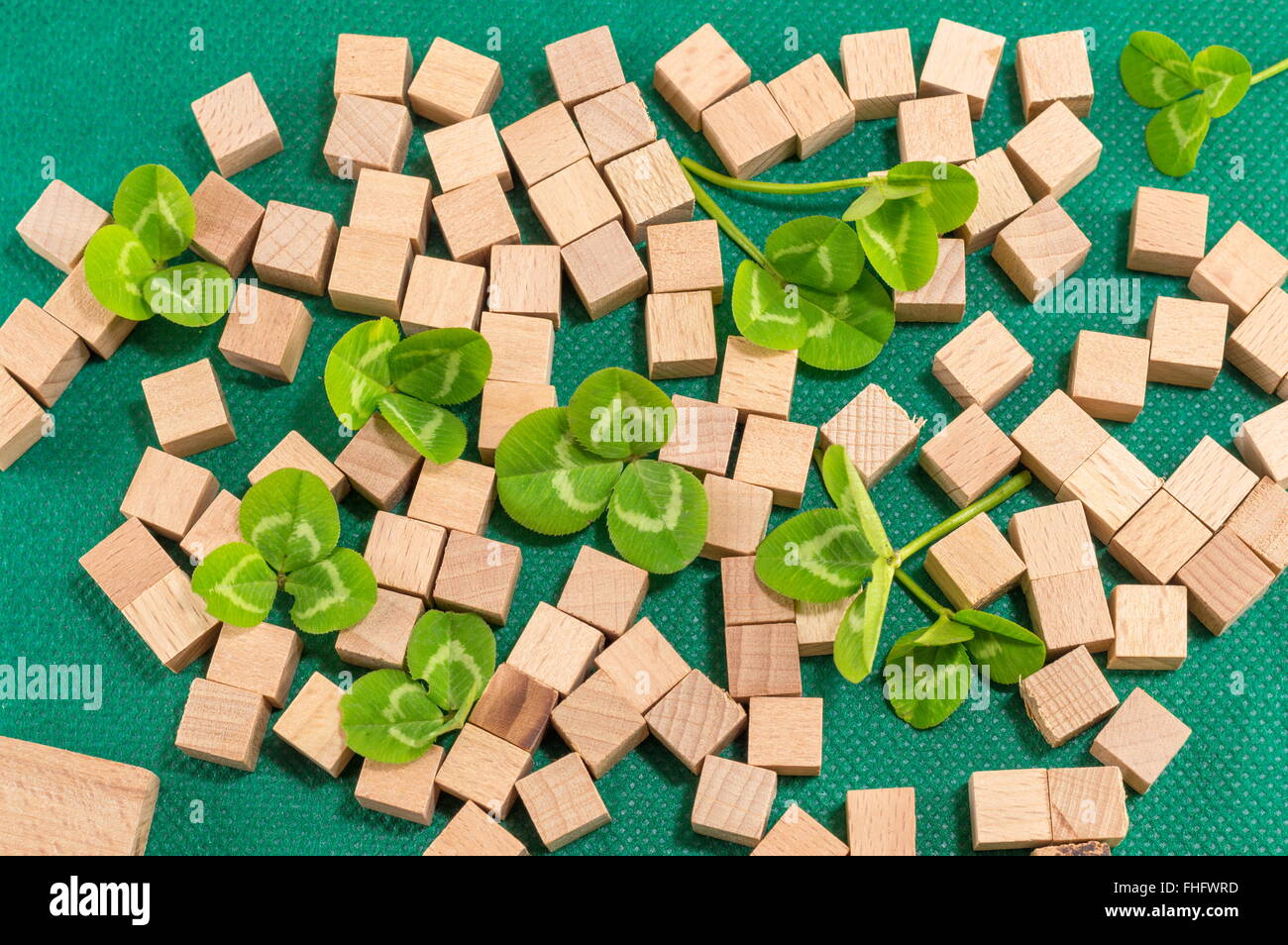 St. Patrick decoration with clover and small wooden cubes Stock Photo